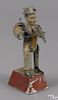 Gunthermann hand painted tin clockwork one-man band with a music box, 9 3/4'' h.