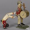 Two German painted tin clockwork performer toys, to include a drummer with a dancing dog