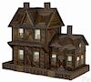 Tramp art doll house with a shellacked twig facade on recycled wood crates