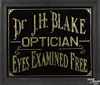 Dr. J. H. Blake Optician reverse painted glass trade sign with gold foil lettering
