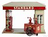 Doll et Cie German painted tin Standard service station with the Standard oil wheel cart