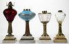 ASSORTED GLASS AND MARBLE KEROSENE STAND LAMPS, LOT OF FOUR,