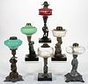 ASSORTED FIGURAL STEM GLASS AND METAL KEROSENE STAND LAMPS, LOT OF SIX,