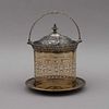 HIELERA. Ca. 1900. Elaborada en vidrio color ámbar, con aplicaciones de metal dorado. Decoraciones orgánicas. Detalles de conservación