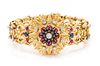 An 18 Karat Yellow Gold Diamond, Ruby and Sapphire Surprise Watch Bracelet, 60.30 dwts.