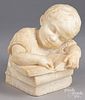 Carved marble bust of a young boy and books