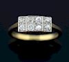 Diamond plaque ring with central raised square section set with four diamonds bordered by two rectangular sections each with 