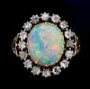 Late Victorian opal and diamond cluster ring, the opal measuring 13.49 x 11.50 mm x 3.44 mm with an old-cut diamond surround 
