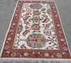 Cream ground rug the centre with styalised foliate forms 240cm x 160cm