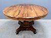 19th century rosewood breakfast table on square column support to shaped base, diameter 120cm