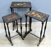 Nest of three Victorian black lacquered papier mache tables with floral decoration. (3)