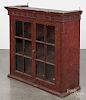 Painted pine hanging cupboard, early 19th c., retaining an old red grained surface, 35'' h., 35'' w.