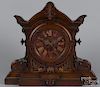 Massive carved walnut mantel clock with a marble face, late 19th c., 22 1/4'' h.