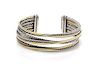 A Sterling Silver and Bonded 18 Karat Yellow Gold Crossover Cuff Bracelet, David Yurman, 35.80 dwts.