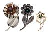A Collection of Sterling Silver, Gemstone and Glass Flower Motif Brooches, 47.70 dwts.