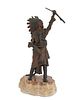 Carl Kauba (1865-1922), A Native American in headdress raising a rifle, Patinated bronze mounted to a stone plinth, 10.5" H x 3.5" W x 4.5" D; with ba