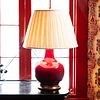 Red Glazed Porcelain and Giltwood Lamp