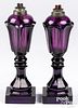 Pair of amethyst glass oil lamps, 19th c.