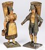Pair of painted tin figures with grape hods