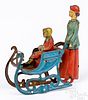 Meier tin lithograph woman pushing sled penny toy