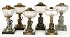 ASSORTED GLASS AND METAL FIGURAL STEM KEROSENE STAND LAMPS, LOT OF SIX