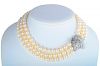 A Three Strand Pearl and Diamond Necklace