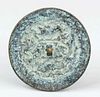 Small bronze mirror, China, probably Han dynasty(202 B.C.-220 A.D.) patinated bronze with mythical creatures between tendrils, eyelet knob, d 7cm, 162