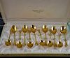 Set of twelve French gilt metal coffee spoons with leaf moulded bowls and coffee bean finials, in fitted case,