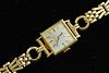 Lady's Rolex 18ct gold watch, square silver dial with gold and black baton hour markers on a fancy 9ct gold link bracelet whi