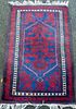 Persian type red ground rug with stepped medallion 130cm x 76cm