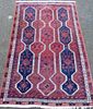 Persian type red ground rug, the cream border with repeating geometric medallions  220cm x 140cm