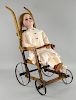 German bisque headed doll in a dolls pushchair,