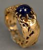 18K ring with reticulated bird design set with cabochon cut blue sapphire. 
8.5 grams