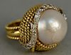 18K gold ring set with large pearl set with twenty-three diamonds, eighteen are in crescent design (pearl with small chip). 
