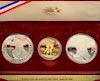 1984 Olympic proof gold and silver set including Olympic gold coin and two silver. 
gold 16.672 grams 21.6 karat 
two silver 
