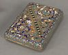 Russian enamel cigarette case having scrolling flower decoration and gold wash interior. 
ht. 2 3/4in., lg. 4in.