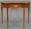 Baker mahogany game table with shaped top over conforming frieze having inlaid glass panels all on square tapered legs in the