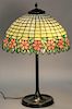 Pink flower leaded and mosaic glass table lamp on bronze base.  ht. 24in., dia. 16 1/4in., shade ht. 8in.