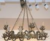 Brass chandelier having center ring and four faces supporting three branch lights on each. 
ht. 32in., dia. 32in.