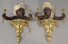 Pair of French polychrome cold painted blackamoor two light wall sconces, bronze and brass, each depicting a painted young bl