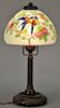 Handel Birds of Paradise boudoir lamp having reverse painted shade of colorful birds perched on blossoming flowering tree bra