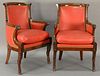 Pair of mahogany fauteuil, each with rounded backs and carved ram's head hand supports set on animal legs with hoof feet, eac