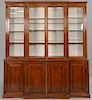 George III mahogany bookcase/cabinet in two parts with four glass doors on lower section with four doors, 19th century. 
ht. 