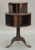 George IV mahogany two tier revolving book stand, each revolving tier with faux books, all set on fluted column on tripod bas