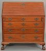 Margolis mahogany Chippendale style desk having slat lid over four graduated drawers flanked by fluted quarter columns, inter