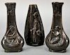 Peter Tereszczuk (1895-1925) 
Three bronze vases including a pair with nearly nude women playing instruments and the other ha