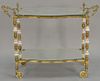 Brass tea cart, two shelf with mirror tops and porcelain mounted legs.  ht. 32 1/2in., lg. 44in.