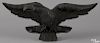 Carved pine eagle, late 19th c., retaining an old black surface, 8'' h., 18'' w.