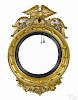 Giltwood convex mirror, ca. 1800, with an eagle crest, 34'' h.