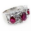 . 2.50 Carat Round Brilliant and Baguette Cut Diamond, Oval Cut Ruby and 18 Karat White Gold Ring.